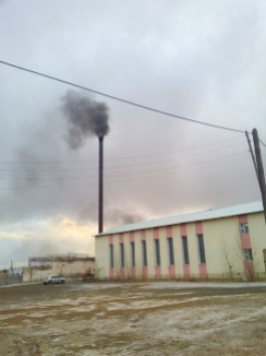 School gym in shadow of heat waste smoke