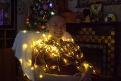 Byamba posing with Christmas lights